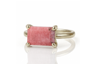 a close up of a ring with a pink stone