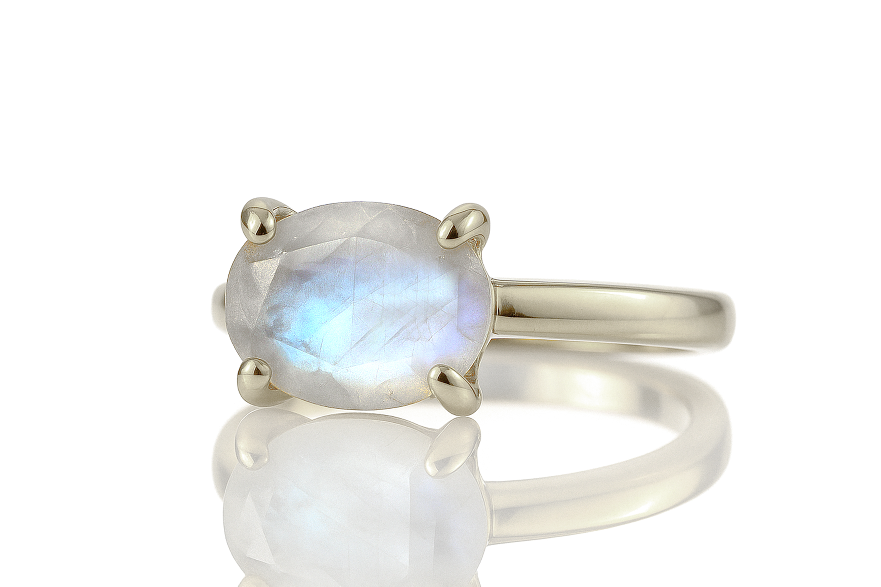 a close up of a ring with a white stone