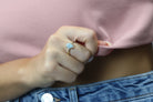 a close up of a person wearing a ring