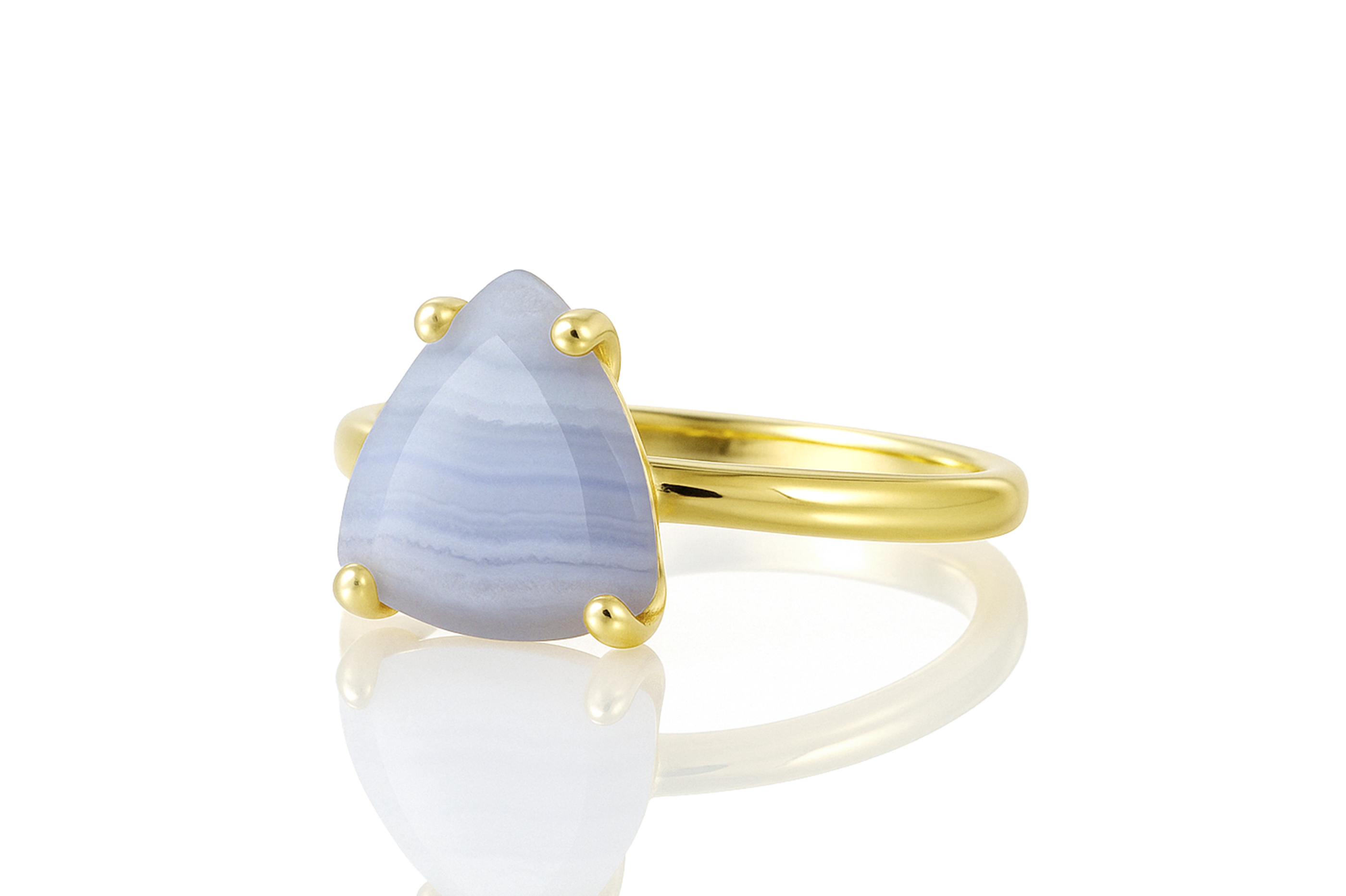 a yellow gold ring with a blue stone