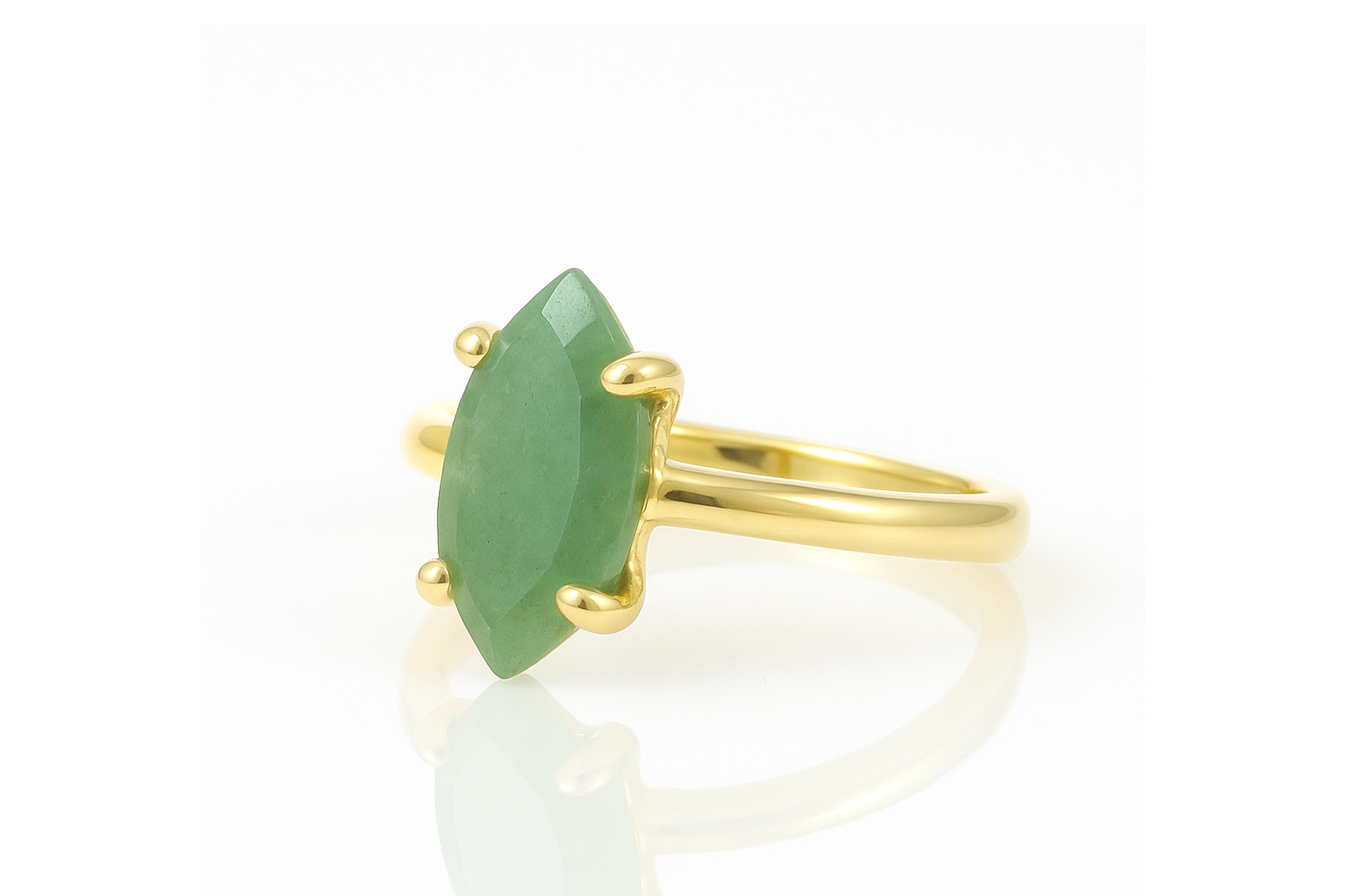 a gold ring with a green stone on it