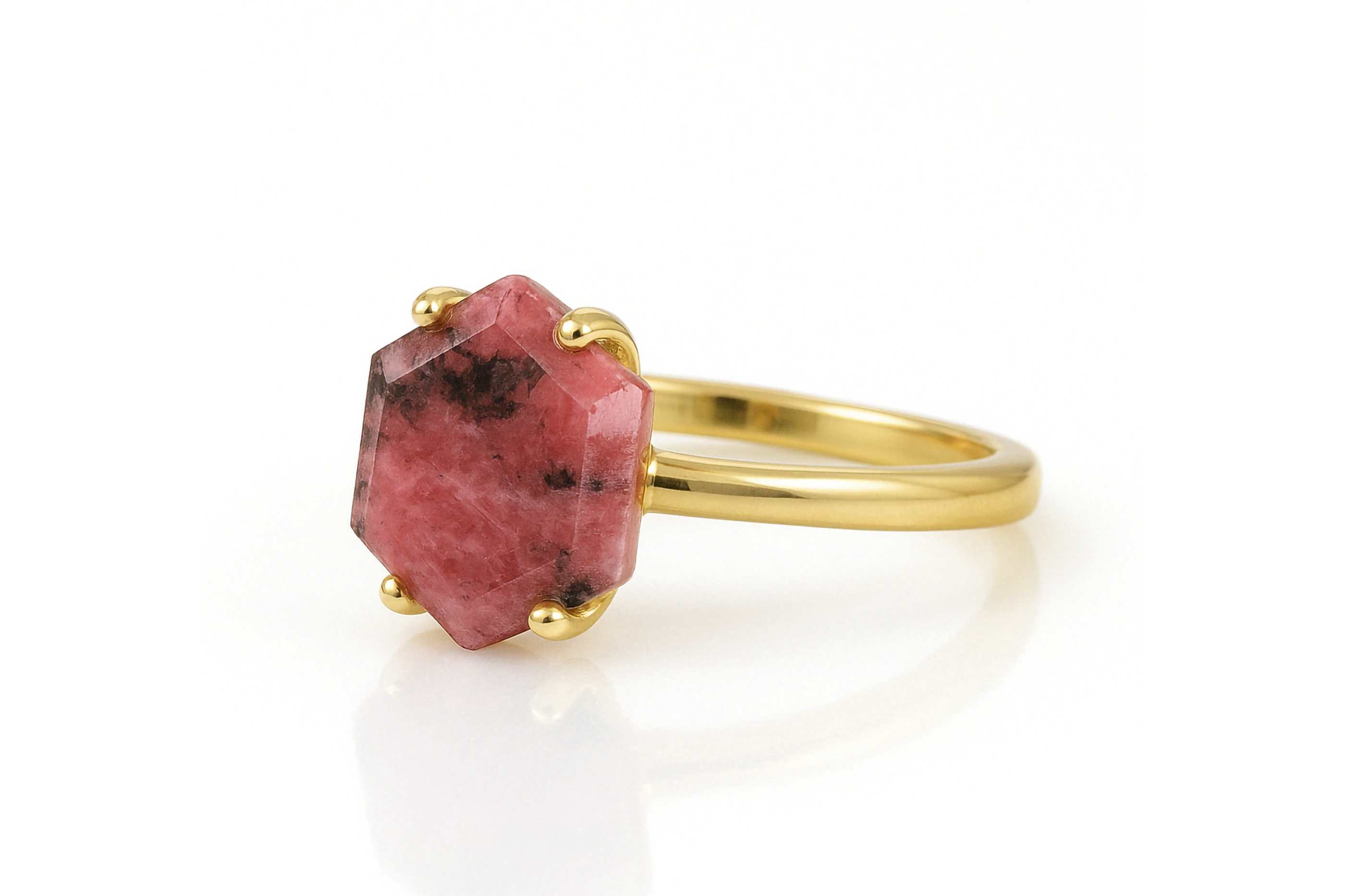 a gold ring with a red stone on it