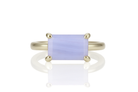 a yellow gold ring with a blue stone