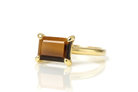 a yellow gold ring with a brown stone