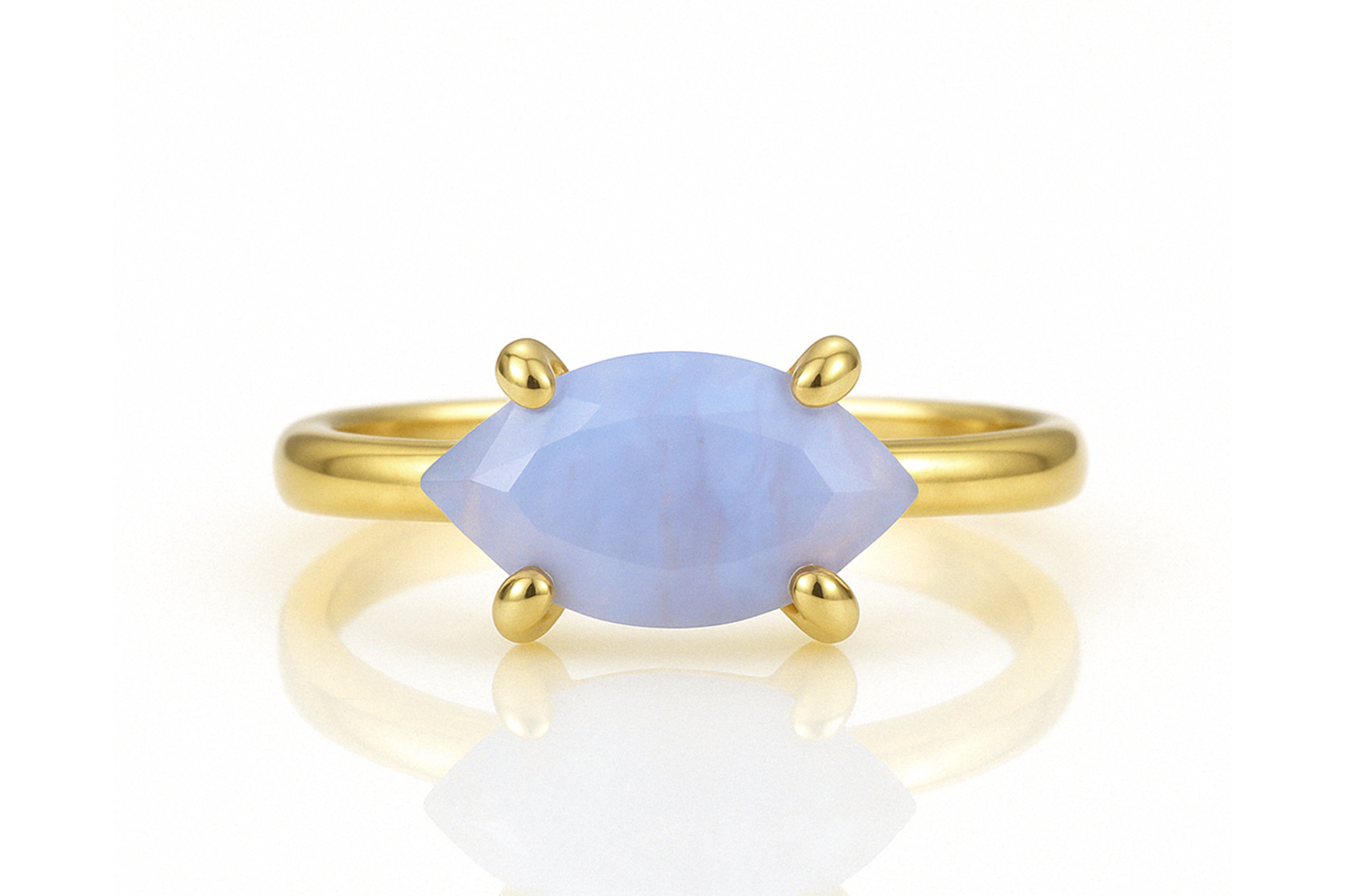 a gold ring with a blue stone on it