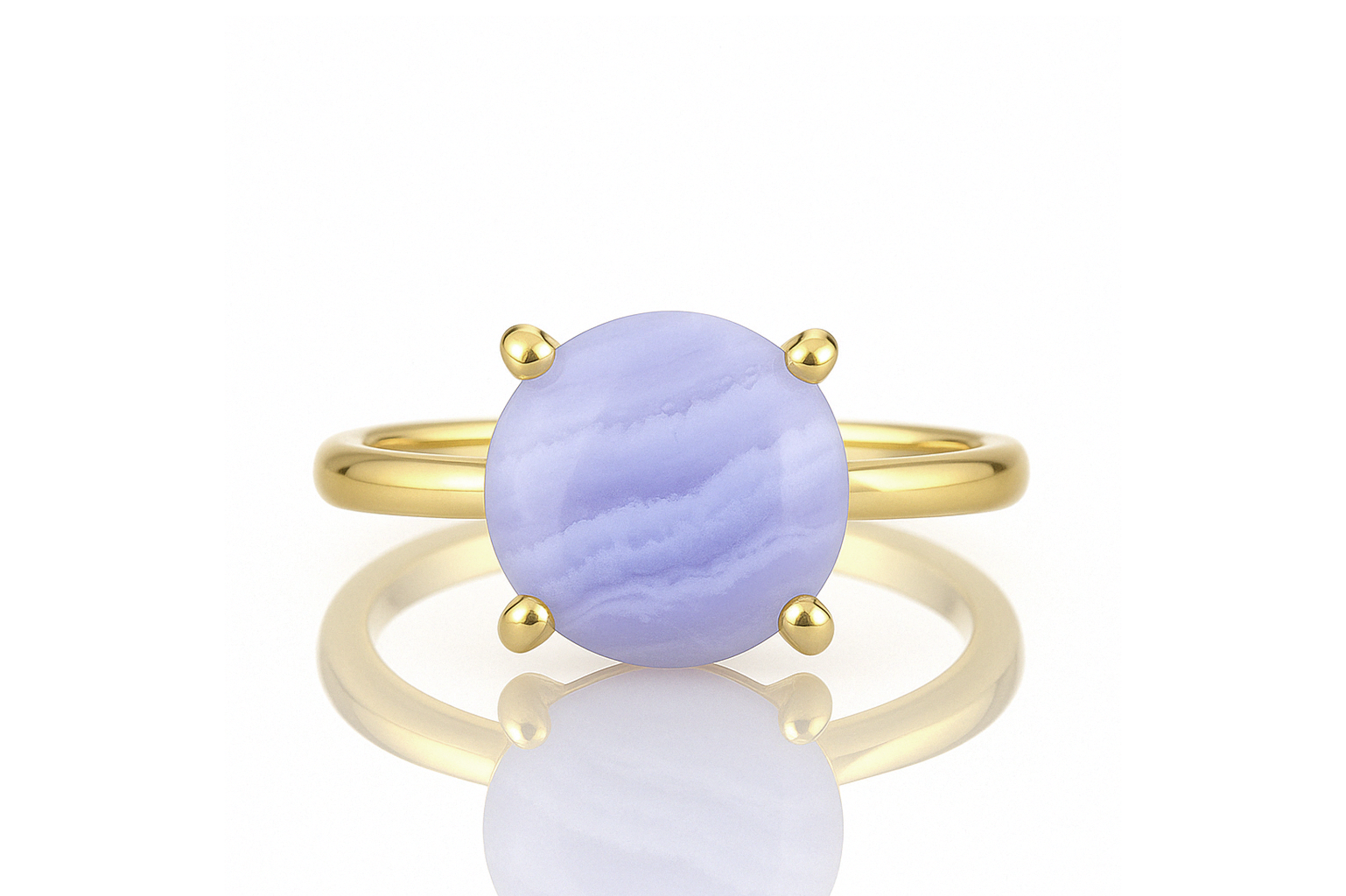 a yellow gold ring with a blue stone