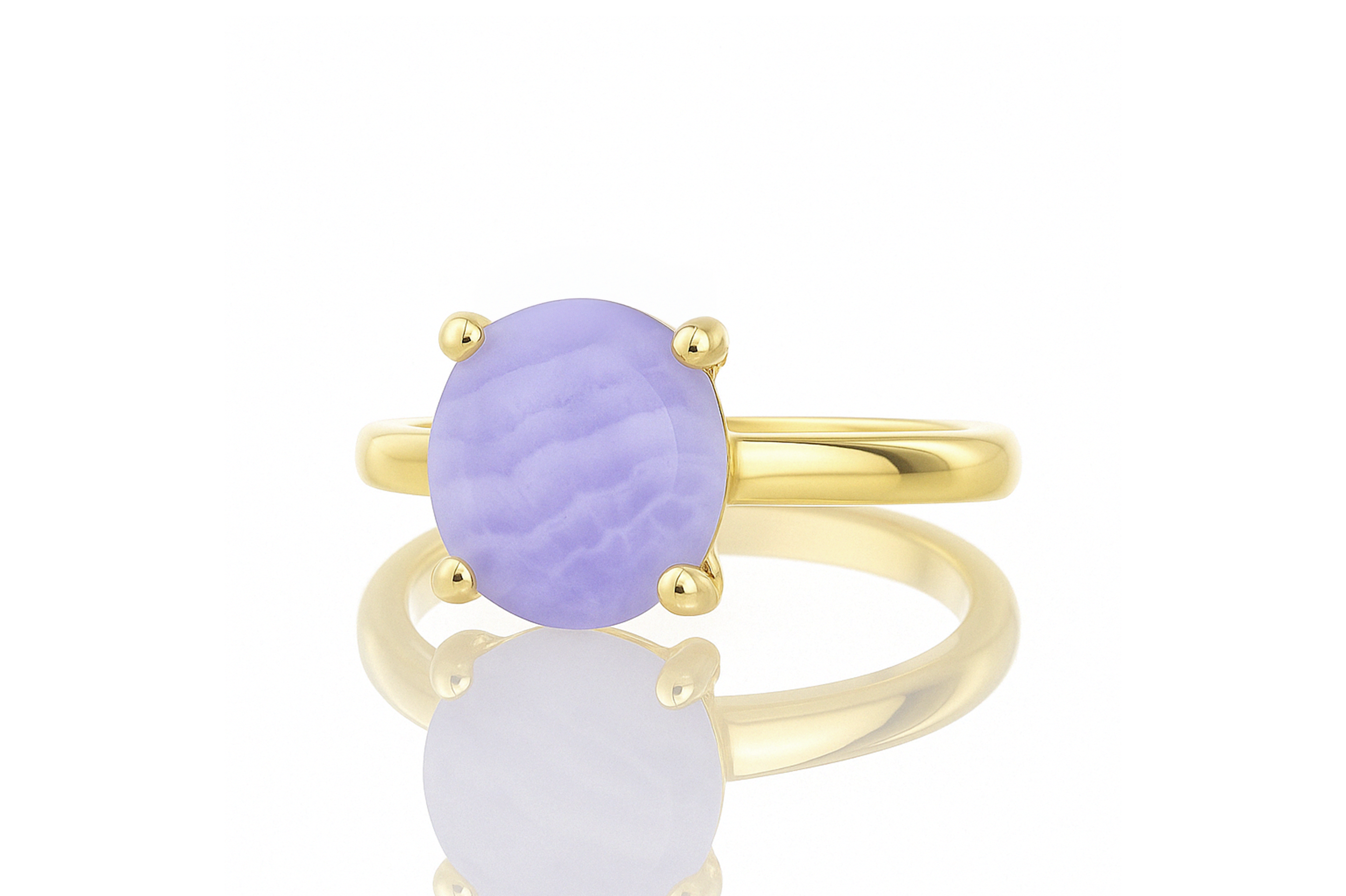 a yellow gold ring with a purple stone