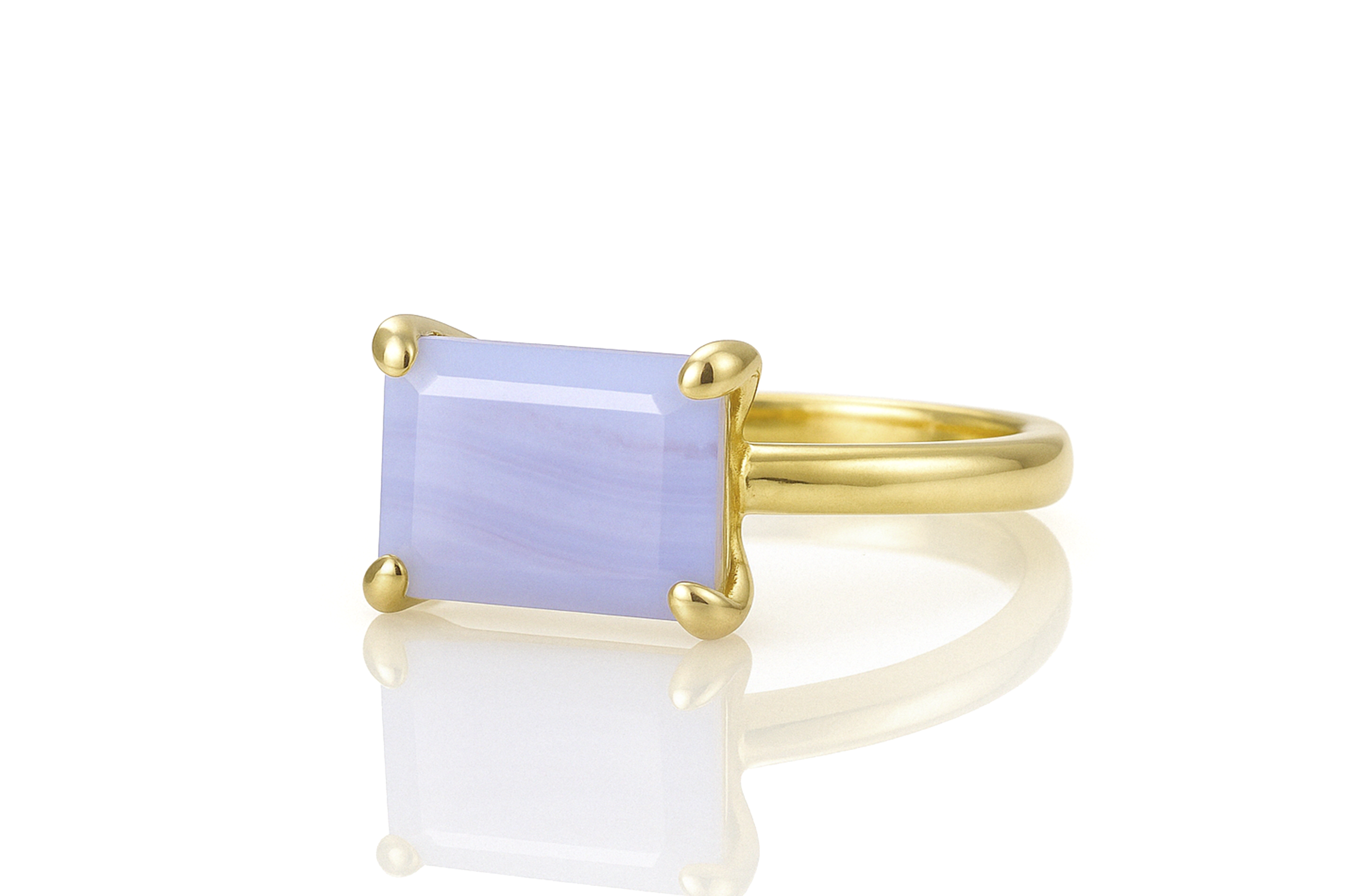 a yellow gold ring with a blue stone