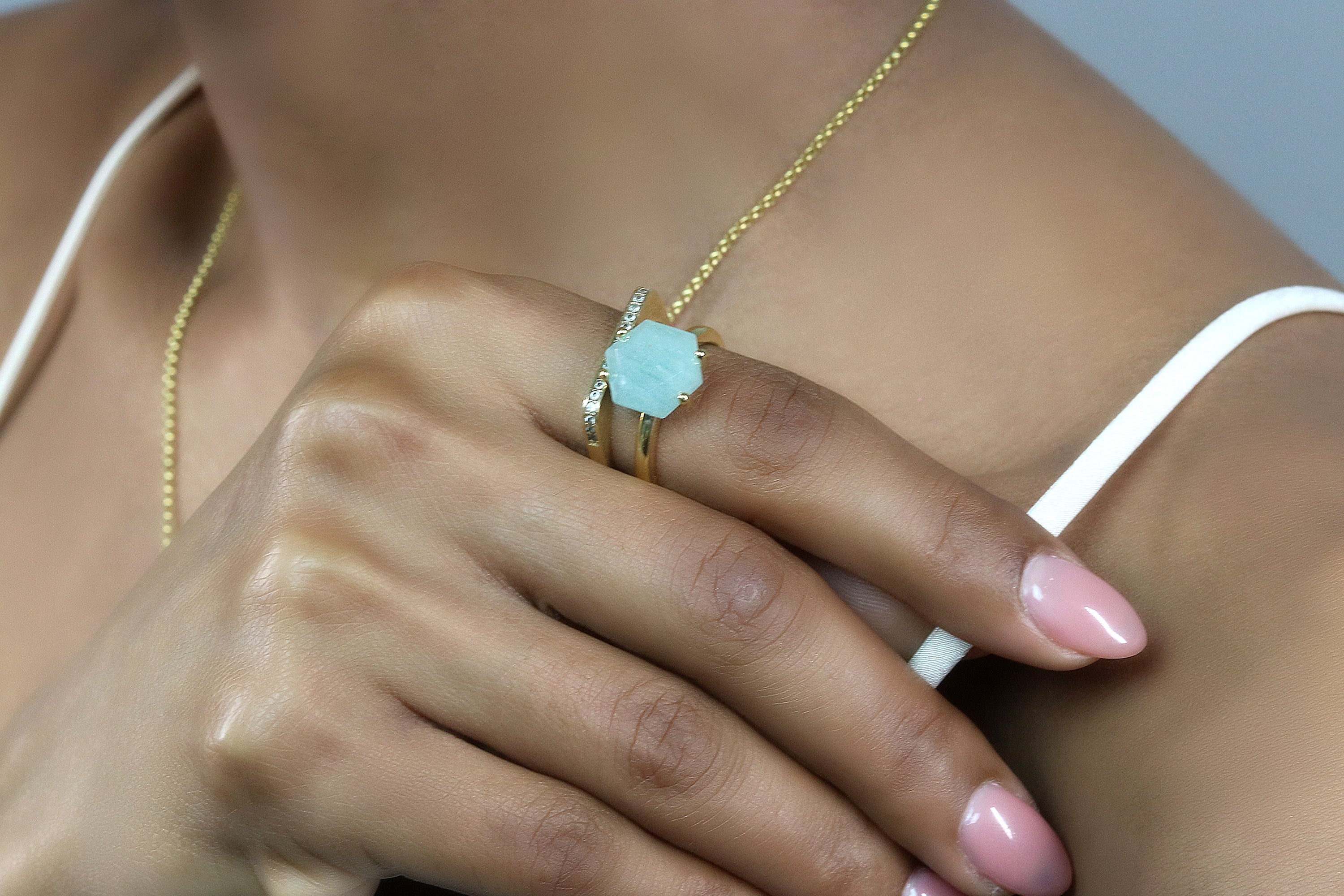 a woman wearing a ring and a necklace