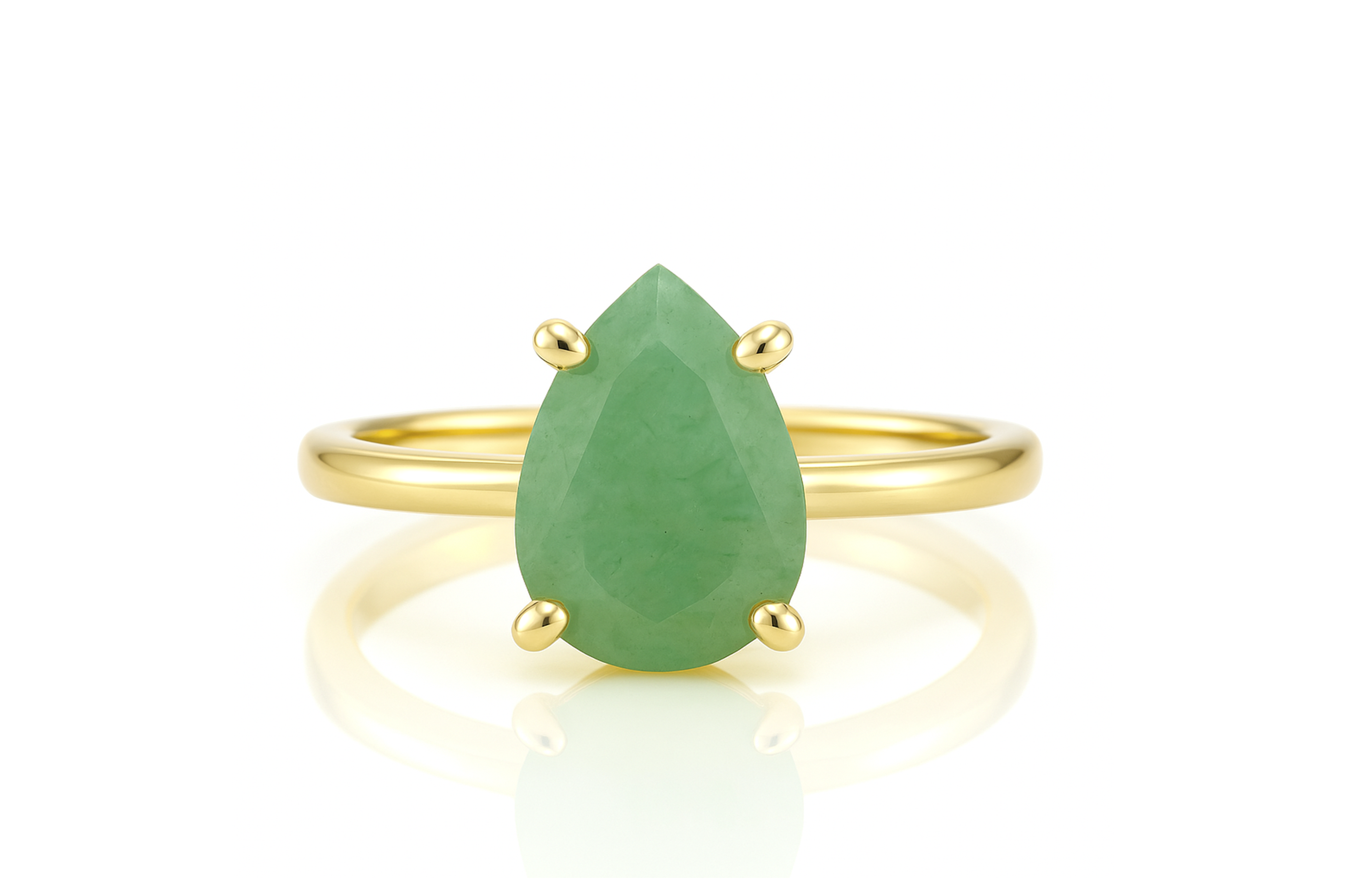 a yellow gold ring with a pear shaped green stone