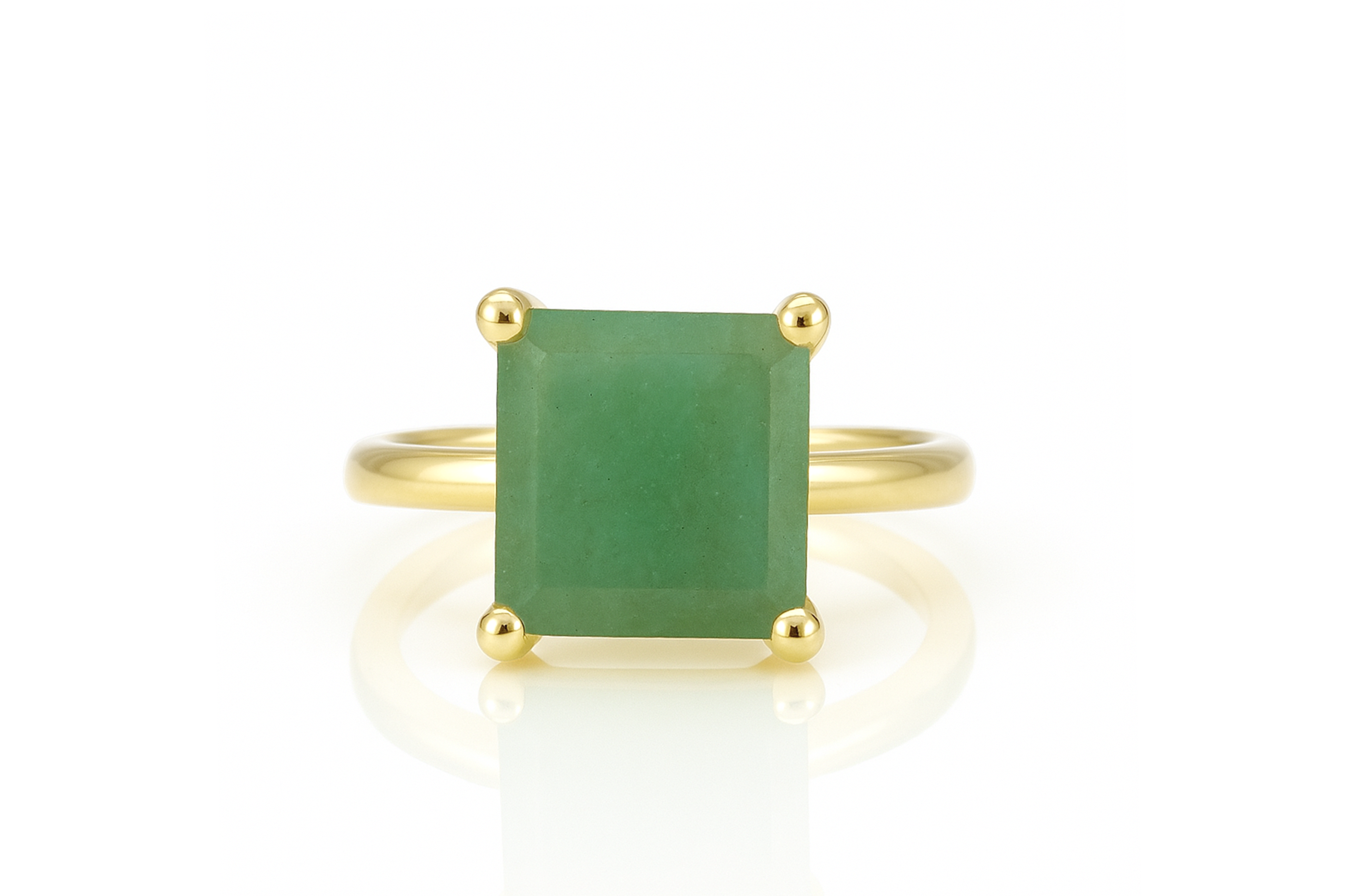 a gold ring with a green stone on it