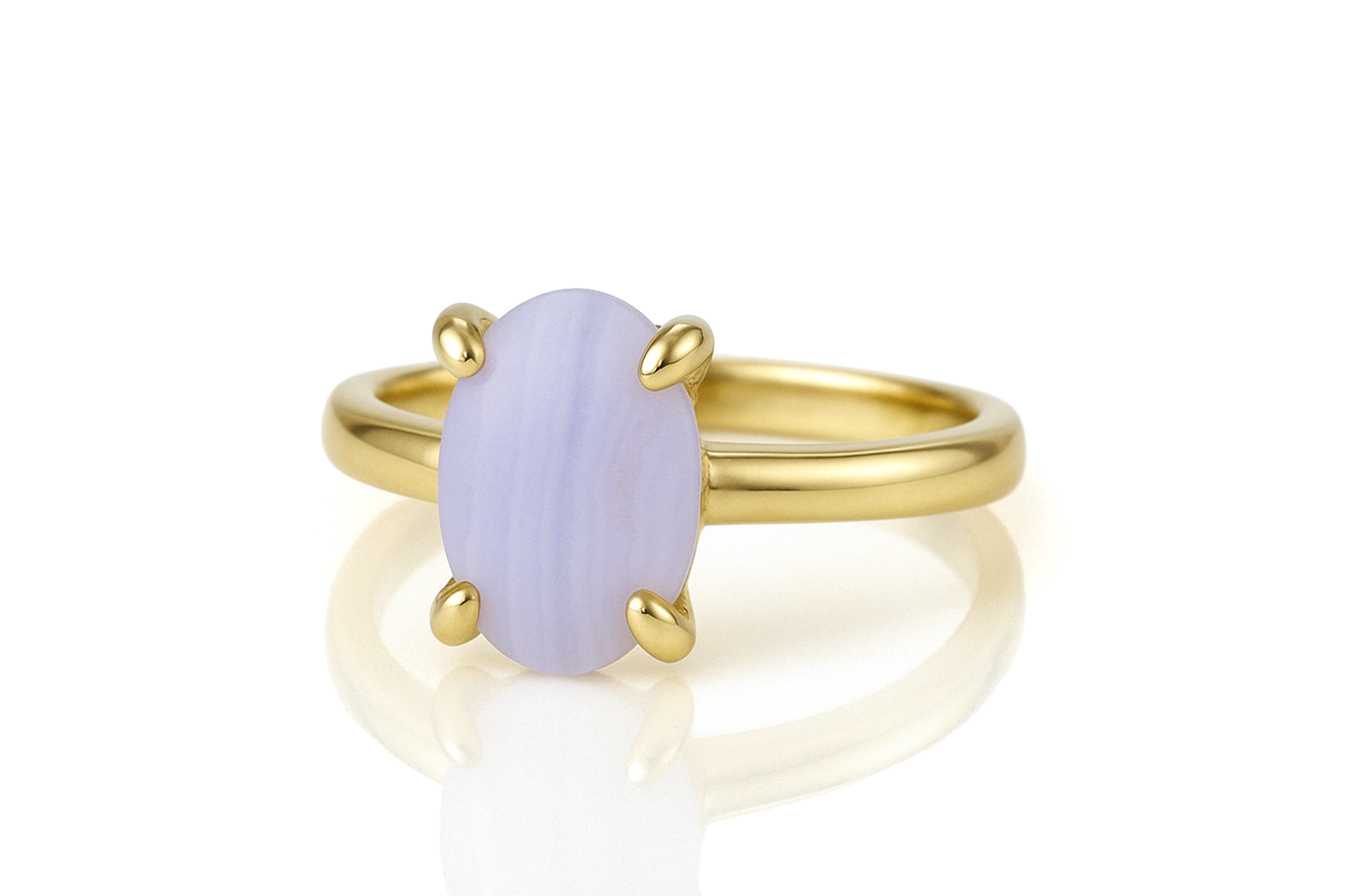a yellow gold ring with a purple stone