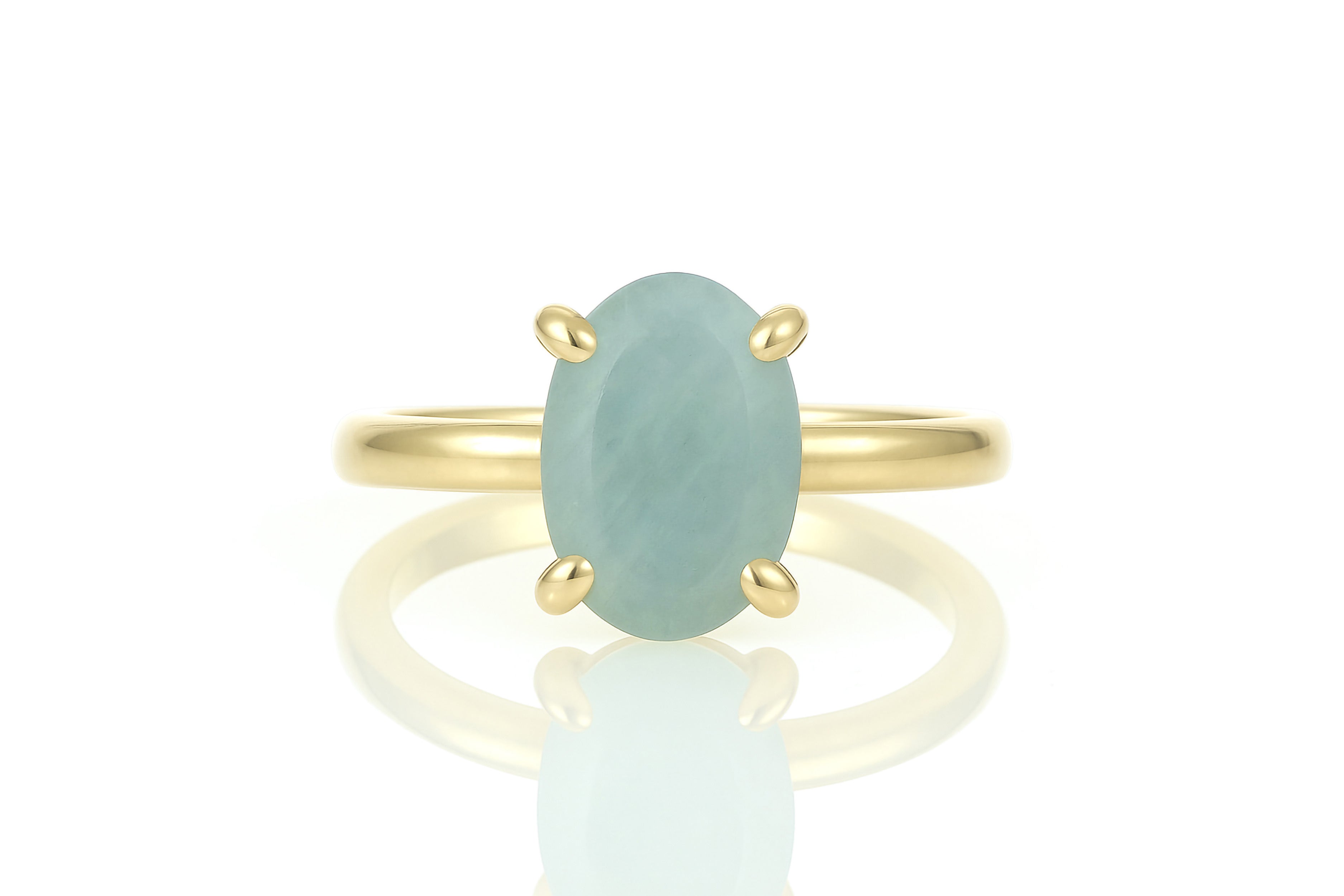 a gold ring with a green stone on it