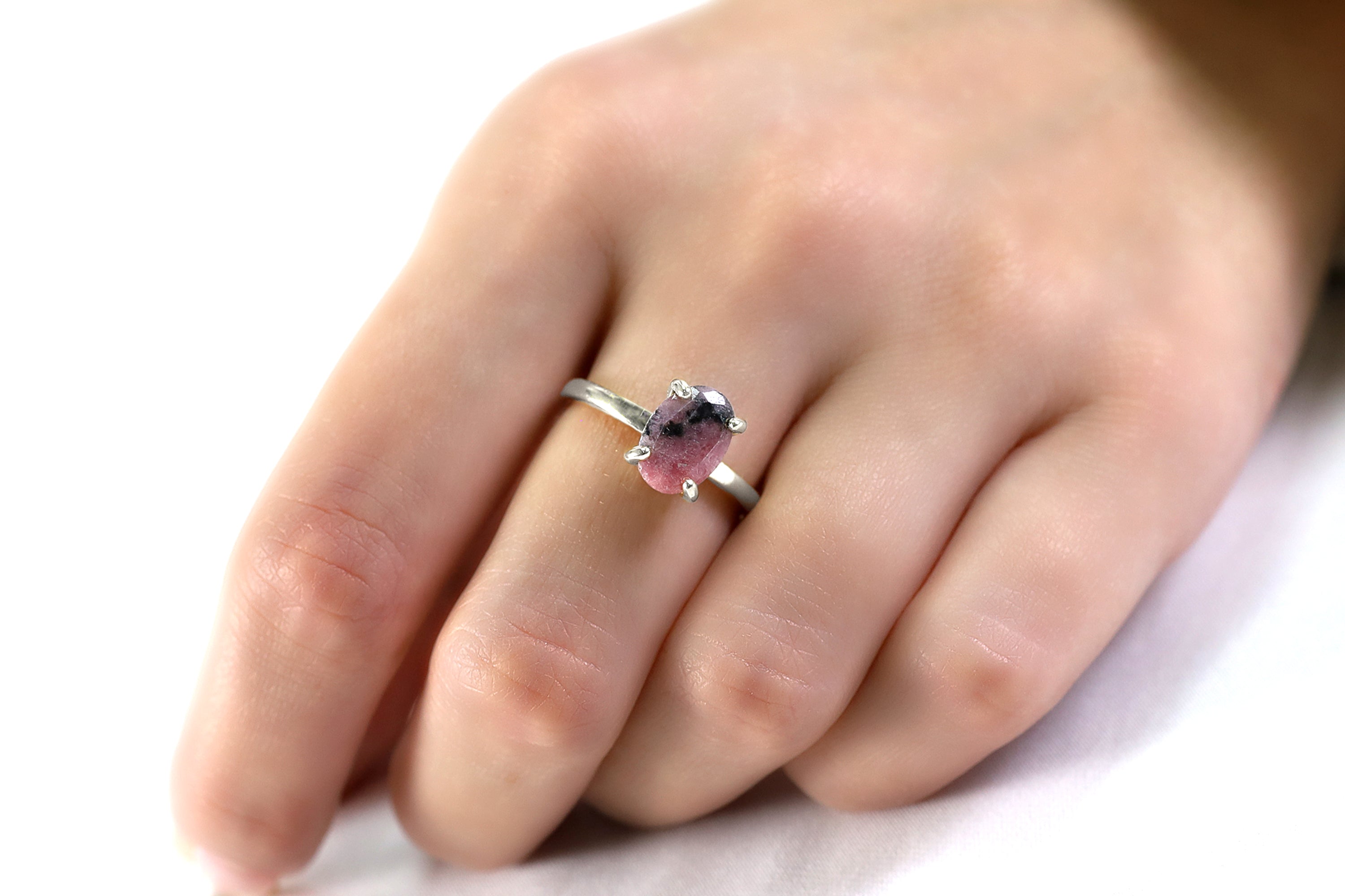 a close up of a person's hand with a ring on it