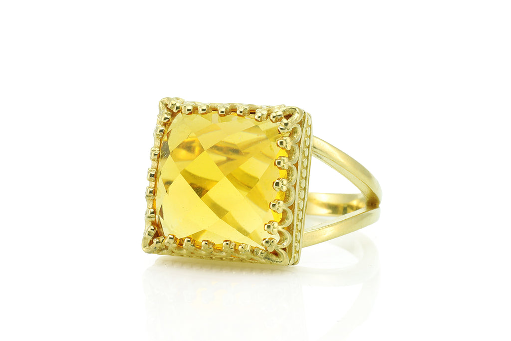 a yellow ring with a square cut stone